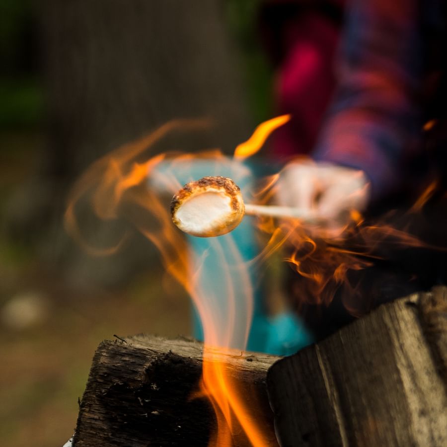 Backpacker using a camping stove to prepare a meal in the wilderness