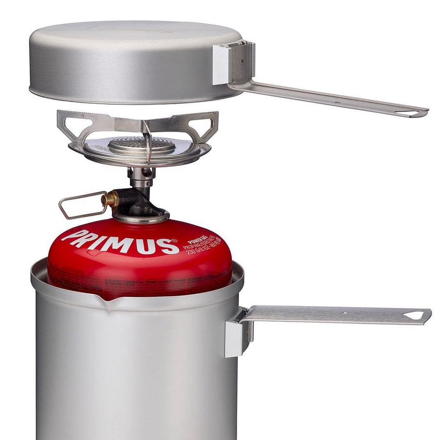 Backpacker using an isobutane-propane stove in the wilderness