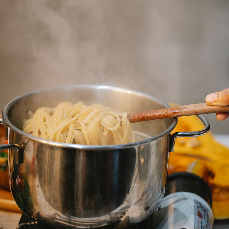 Backpacker cooking meal with lightweight camping cookware in the wilderness