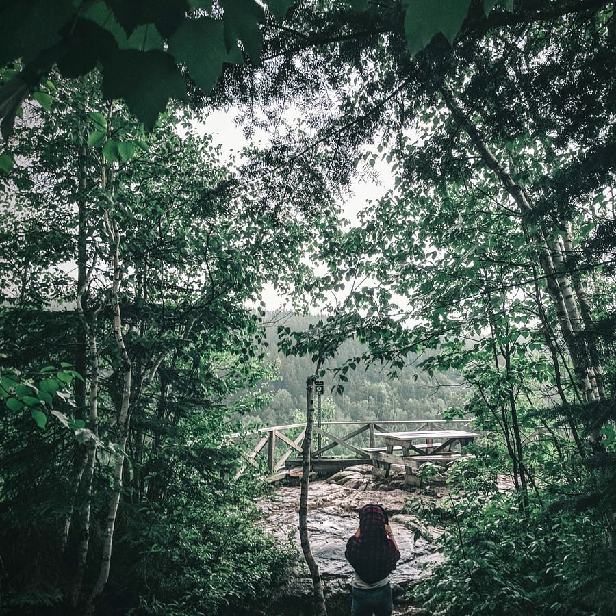 Hiker examining various lightweight camping cookware sets