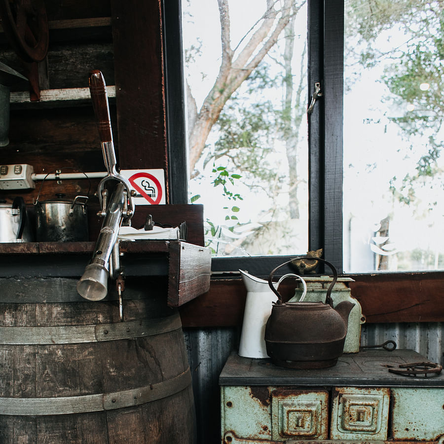 Camper following safety precautions while using a multi-fuel stove