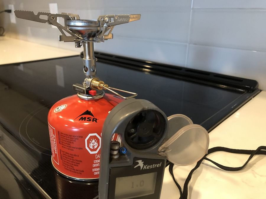 Backpacking stove operating under windy, high-altitude conditions